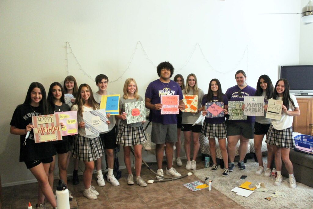 Image of high school students showing the signs they made for Maggie's Place