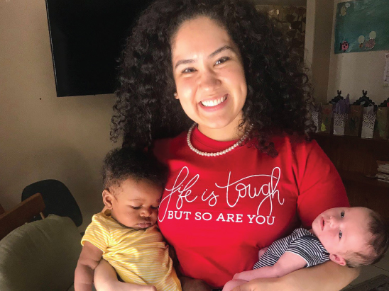 Image of AmeriCorps member holding two babies